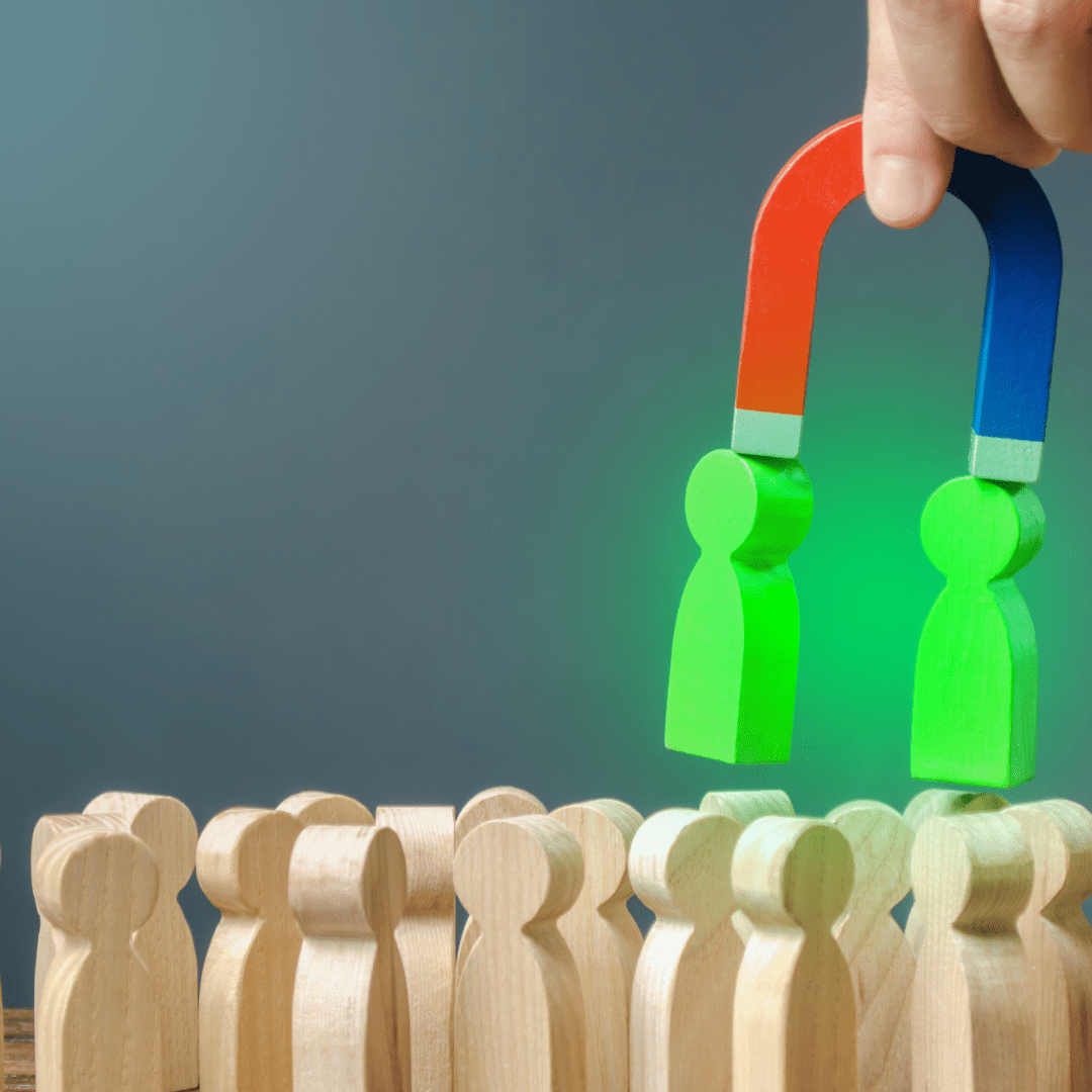  FREE Businessman with a magnet pulls green figures of people out of the crowd